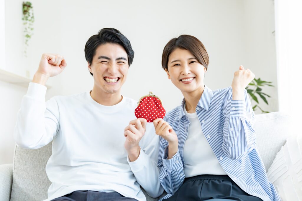 財布を持って喜ぶ夫婦